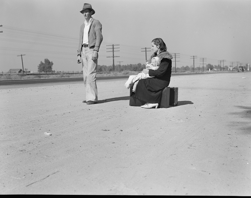 Young family, penniless, hitchhiking on U.S. Highway 99,