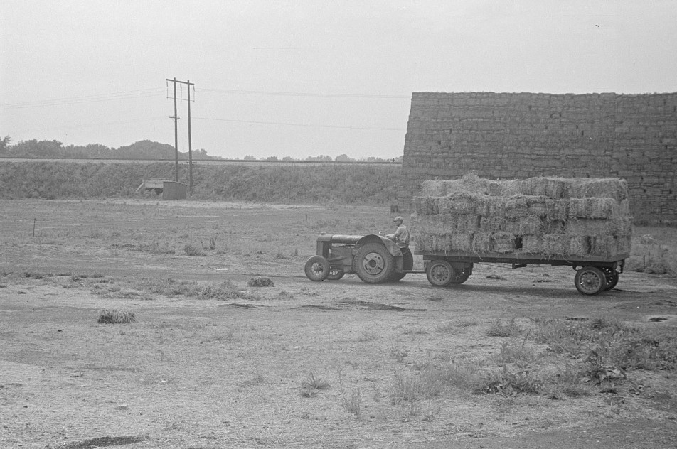 baled straw and tractor