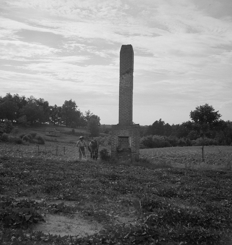 Standing chimneys are a common sight in Greene County. They often stand in gullied fields indicating where a plantation house once stood. Georgia 1937 dorothea lange