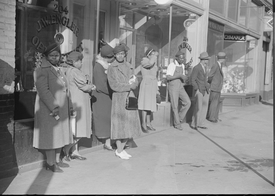 Domestic servants waiting for streetcar on way to work early in the morning. Mitchell Street, 3Atlanta, Georgia