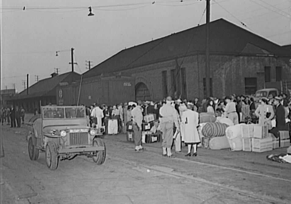 Japanese waiting for a train which will take them to Owens Valley during evacuation of Japanese-Americans from West coast under United States Army war emergency order