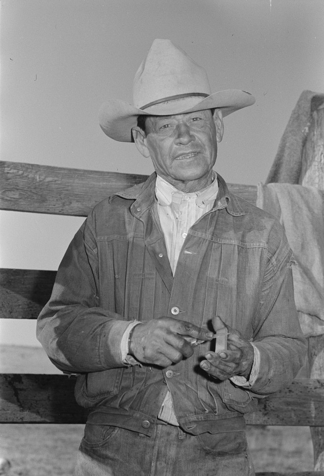 Mexican cowboy sharpening his knife. Roundup near Marfa, Texas photographer Russell Lee May 1939