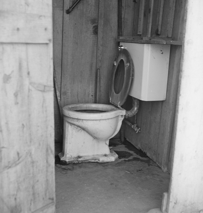 Toilet for ten cabins, men, women and children in auto camp for Arkansawyers, recent migrants to California. Rent for cabins ten dollars a month. Greenfield, Salinas Valley, California